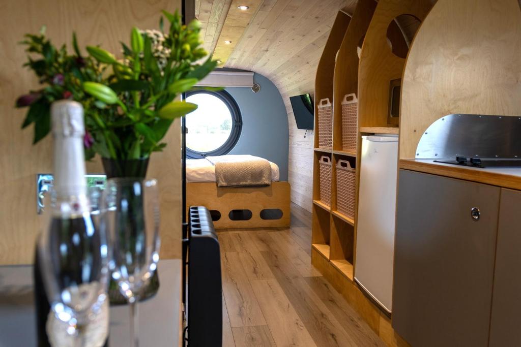 a kitchen with a vase of flowers on a table at Highland Gateway Glamping in Clackmannan