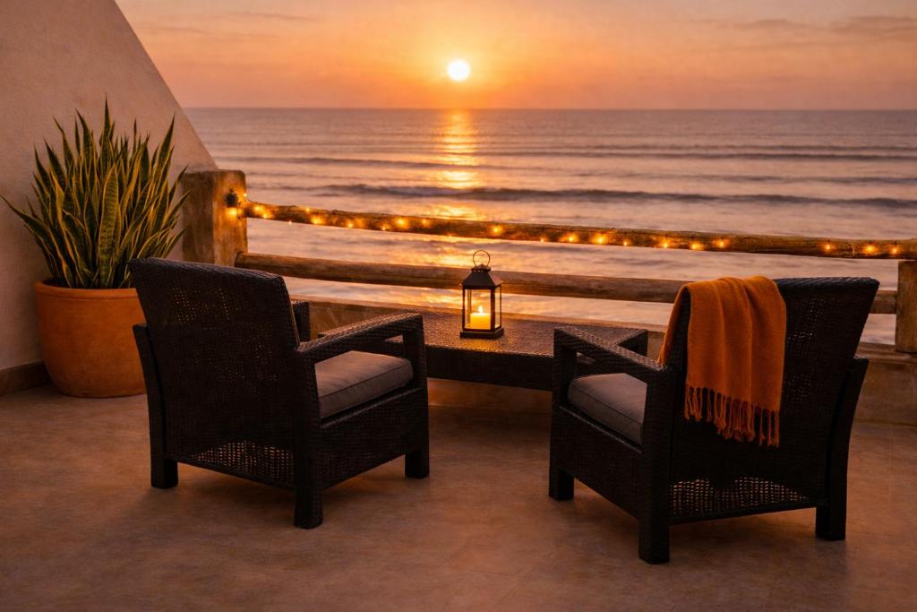 two chairs and a table with a view of the ocean at 2BR Luxury Apartment-Heart Of Taghazout, Private Beach Access, Panoramic View, Remote Work 100Mbps, Walk to Restaurants in Taghazout