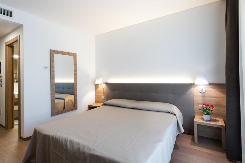 Posteľ alebo postele v izbe v ubytovaní Albergo Al Tarcentino