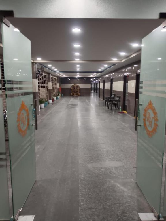 an empty hallway in a building with a long floor at Ram Hari Hara Convention in Khammam