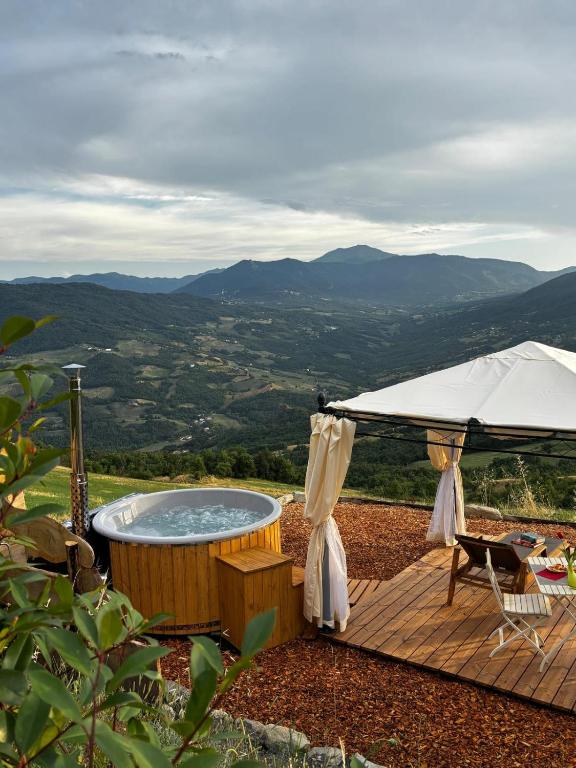 a hot tub on a wooden deck with a view at La Torre in Pavullo nel Frignano