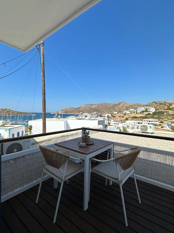 a table and chairs on a deck with a view of the ocean at Casa Bianca in Leipsoi