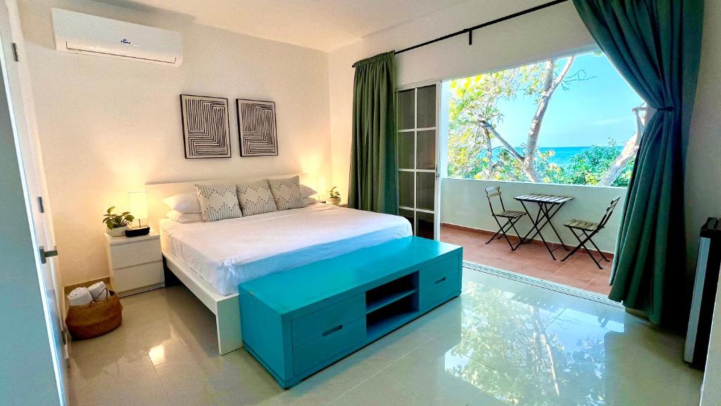 a bedroom with a bed and a large window at Blue Island Punta Rucia in Punta Rucia