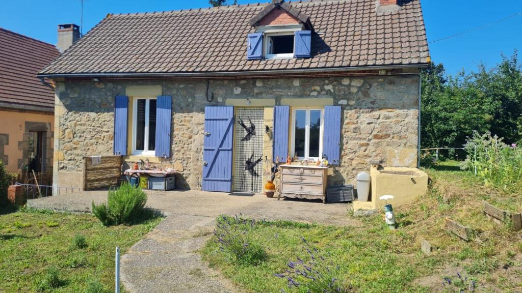 a small stone house with blue doors and windows at Ciel Etoillè in Saint-Bonnet-de-Four