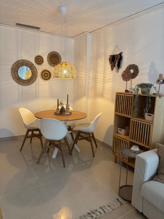 a dining room with a table and chairs and a couch at Casa La Mata in La Mata