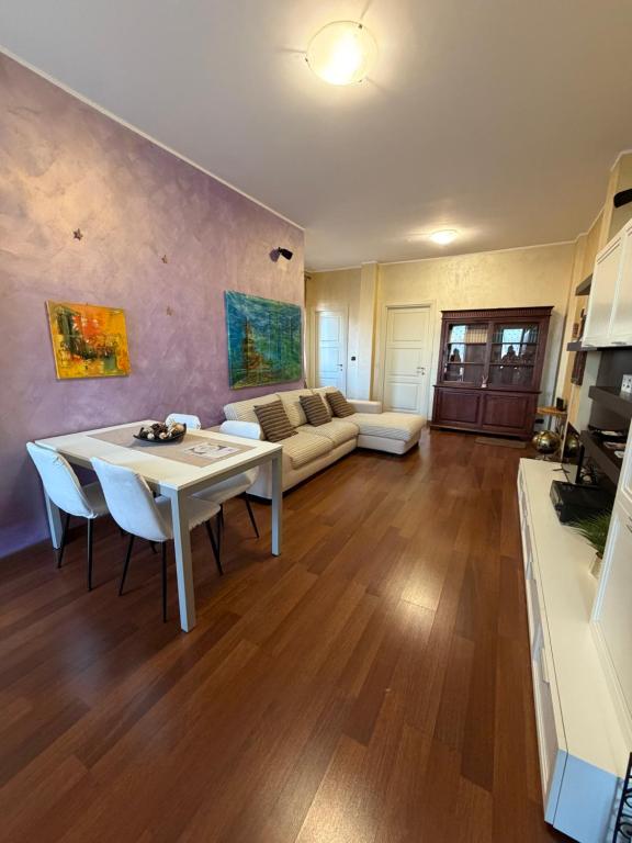 a living room with a table and a couch at La casa di Alice in Orbassano