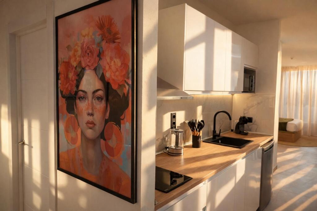a kitchen with a painting of a woman on the wall at DozZze Julieta in Alicante