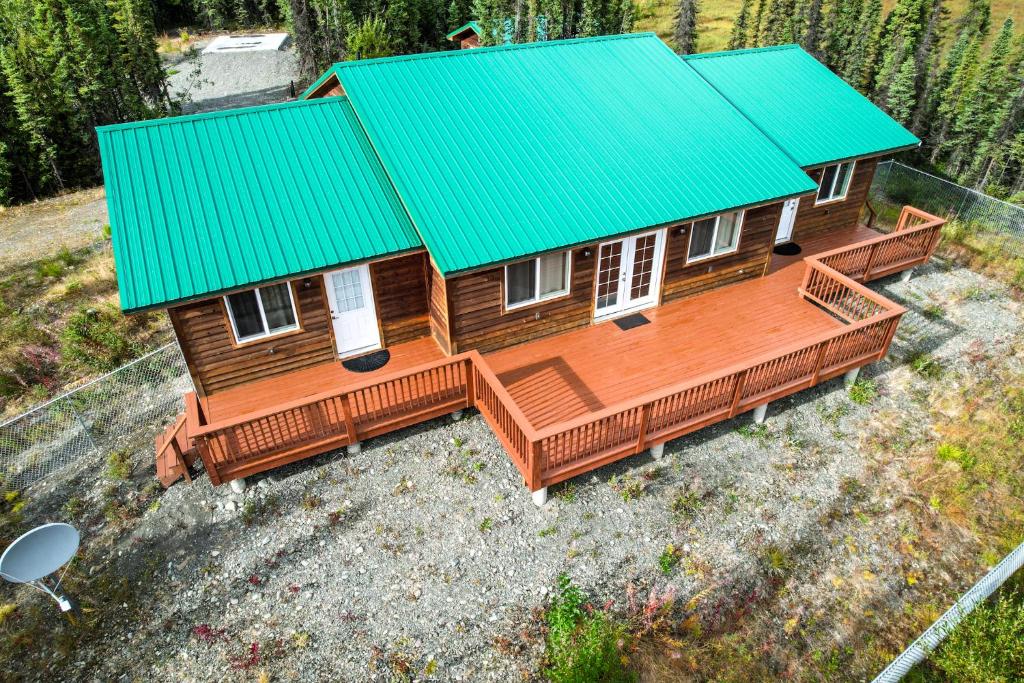an overhead view of a wooden house with a green roof at Soldotna-Kenai Peninsula House in Soldotna