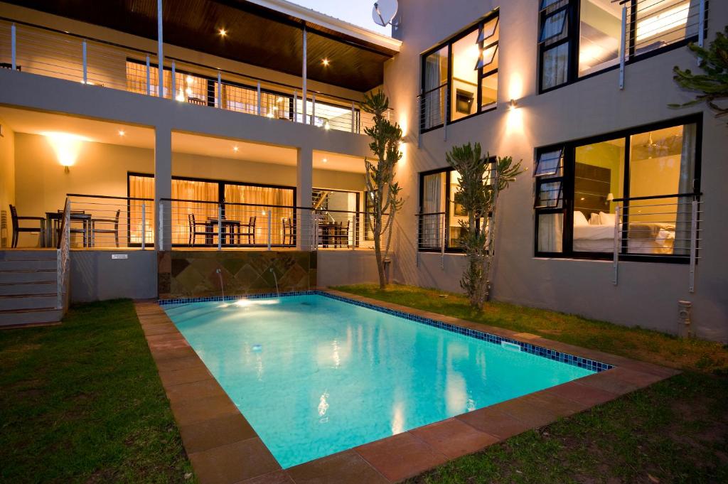a swimming pool in front of a house at The Hub Urban Hotel in Port Elizabeth