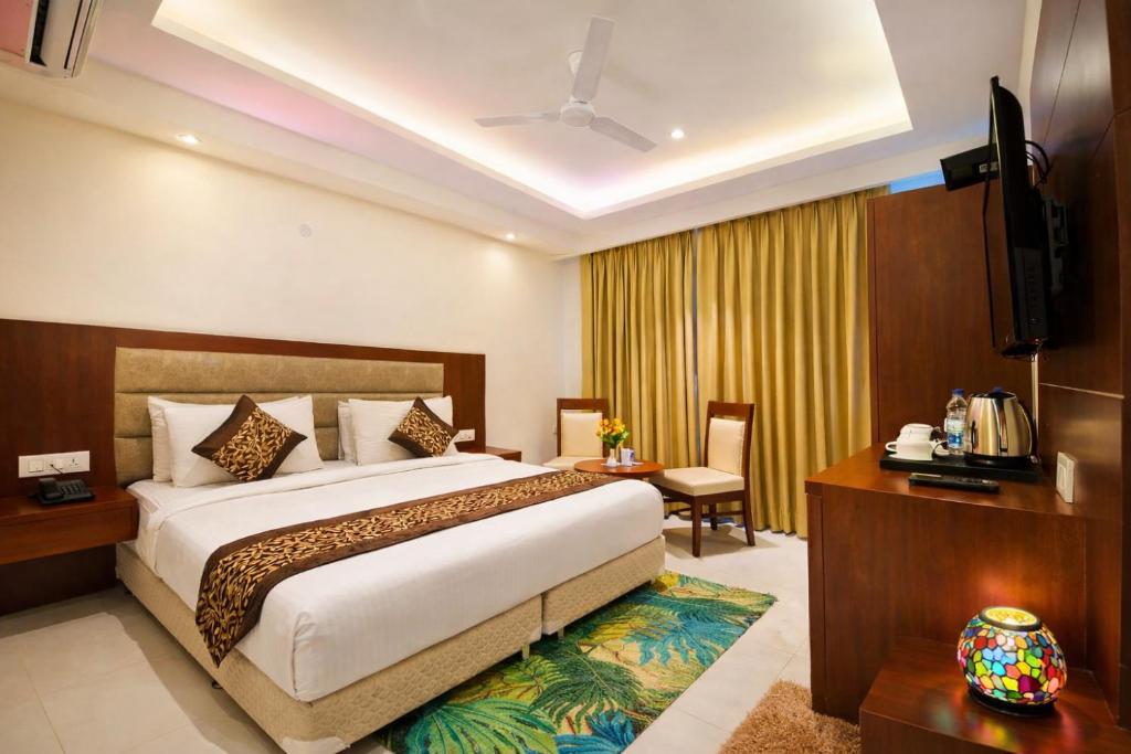 a hotel room with a bed and a television at Yashobhoomi Hotel Z Suites- FREE Airport Pickup & Drop in New Delhi