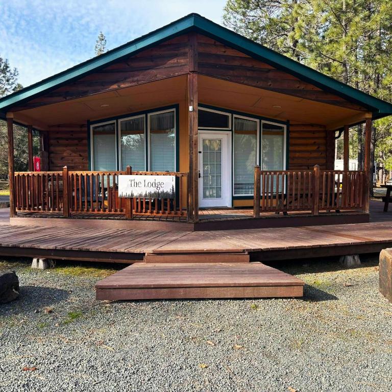 a log cabin with a porch and a sign on it at The Lodge in O'Brien