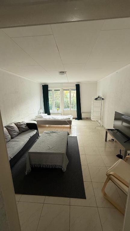 a living room with a couch and a table at Ribe Villa in Stockholm