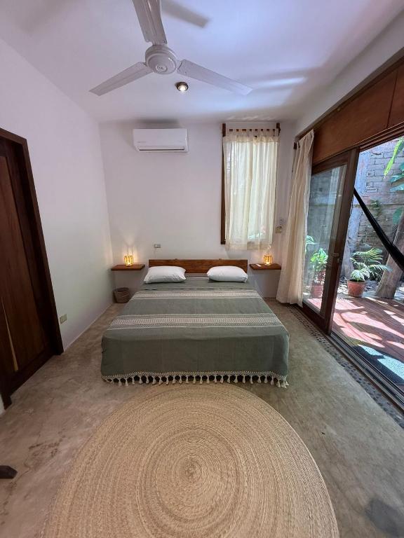 a bedroom with two beds and a ceiling fan at la baxada mazunte in Mazunte