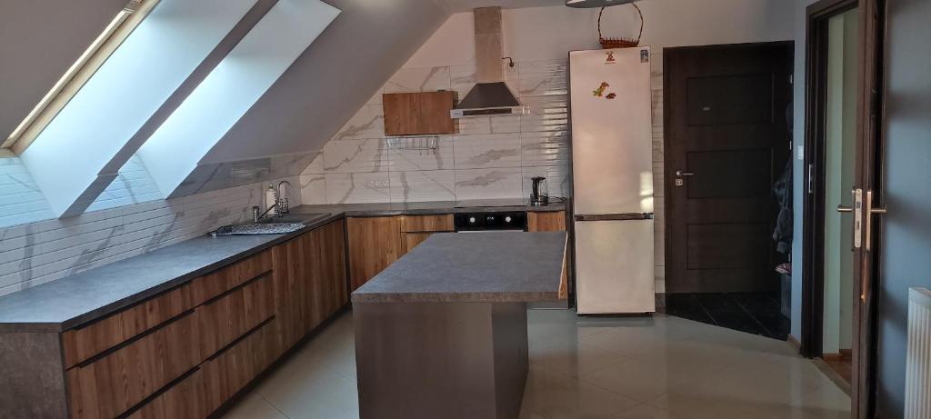 a kitchen with a sink and a refrigerator at ELEKTRa in Stare Bielice