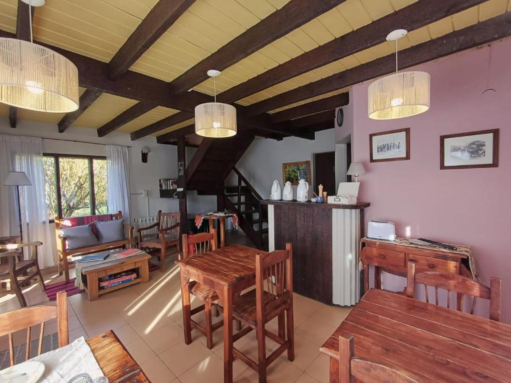 a living room with wooden tables and chairs at Casa Viedma in El Chalten