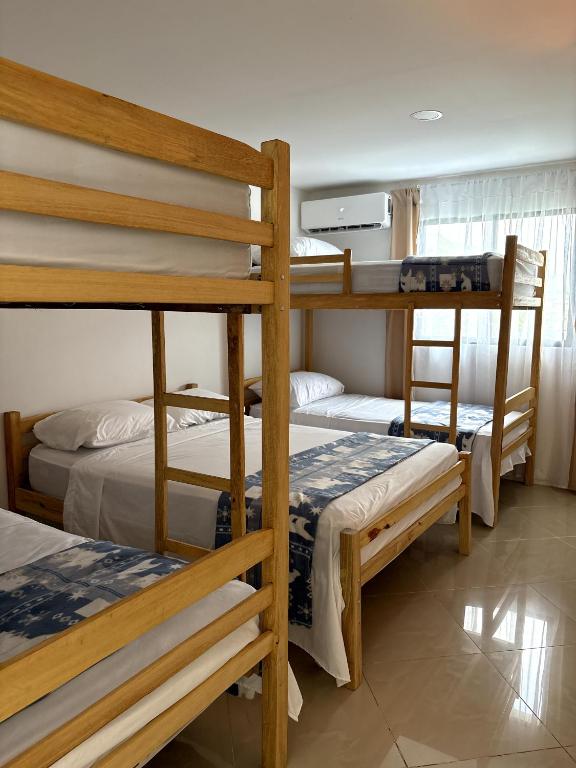 a bedroom with three bunk beds in a room at Sol Coral in Valdivia