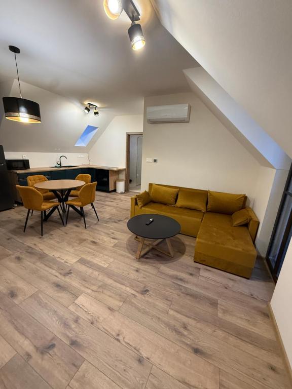 a living room with a couch and a table at Apartman Mia 5 in Liptovský Mikuláš