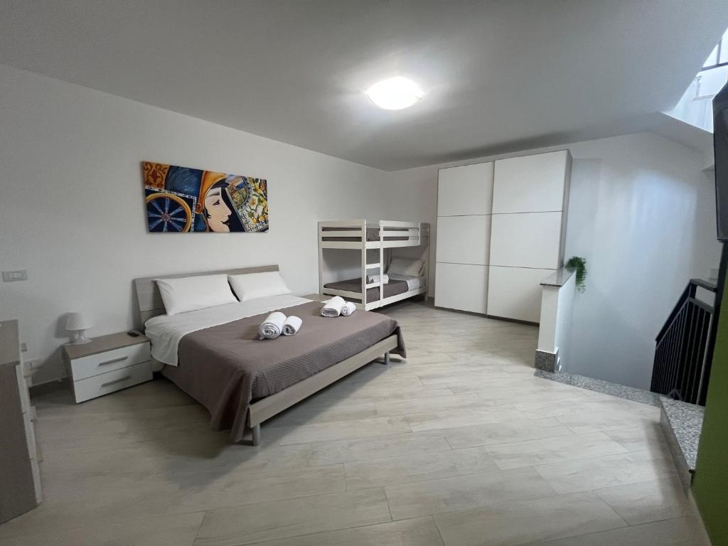 a bedroom with a bed with two stuffed animals on it at Trinacria Rooms 2 in Carini