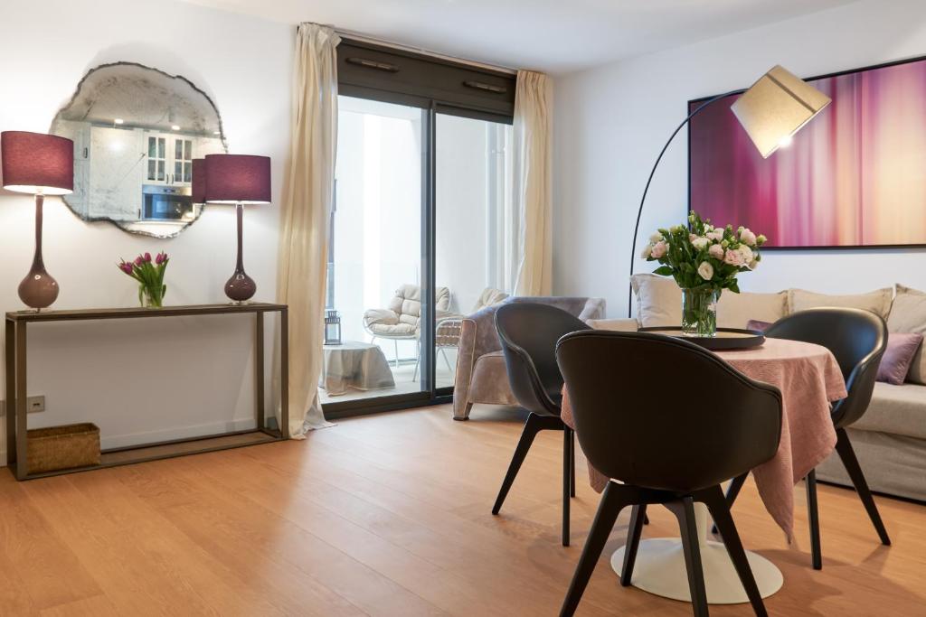 a living room with a table and chairs at Monaco Bliss apartments 5 min to Casino in Beausoleil