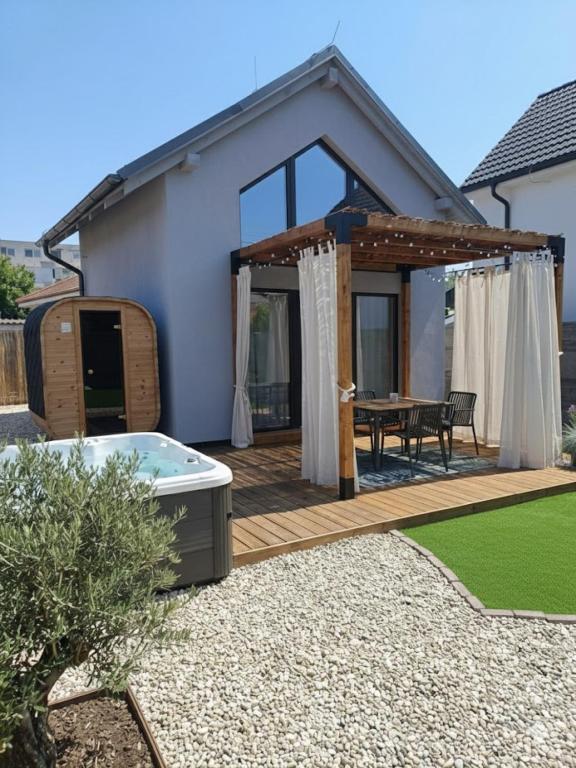 a house with a deck with a hot tub at Tiny Loft Šamorín - s privátnym wellness, saunou a vírivkou in Šamorín
