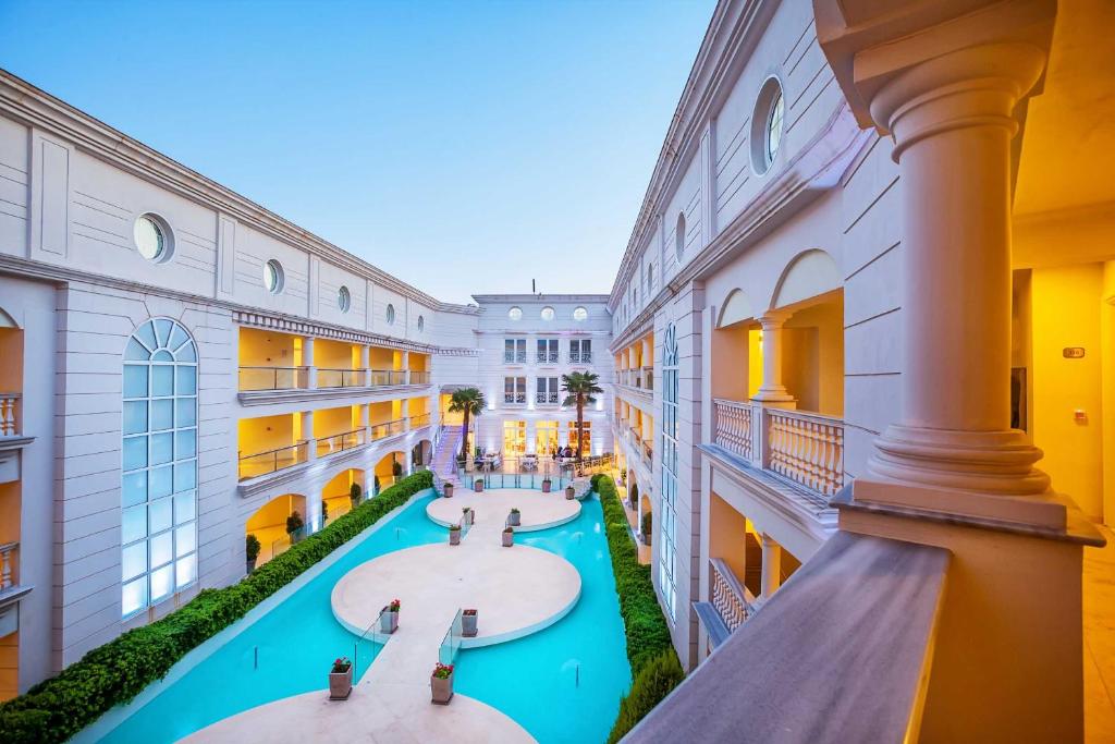 an indoor courtyard with four sinks in a building at Elinotel Apolamare Hotel in Hanioti