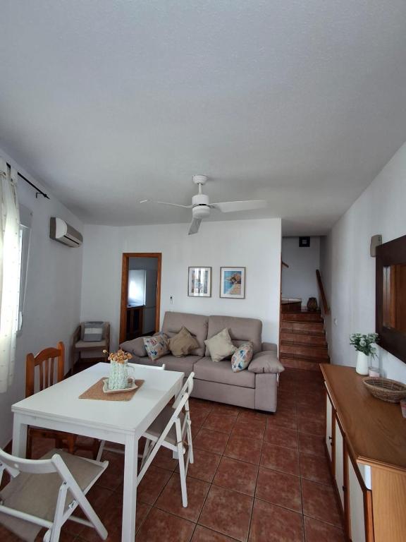 a living room with a couch and a table at Duplex Barbados Aguamarga in Agua Amarga