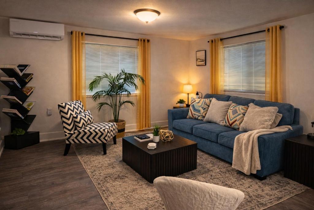 a living room with a blue couch and chairs at King Suite and Sofa Bed Fast WI-FI Easy DC Access in District Heights