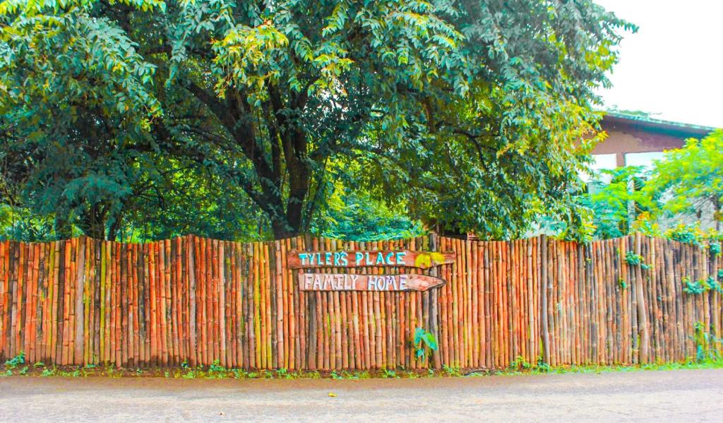 a fence with a sign that reads there is a fenceabies placeenough at Tyler's place in Coco