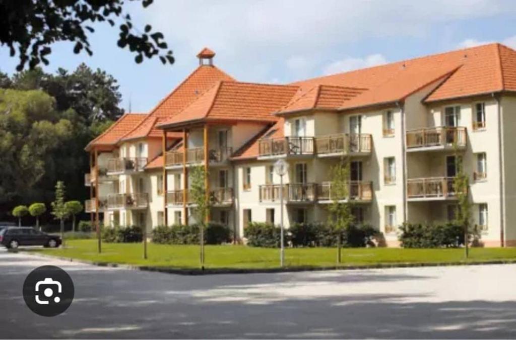 a large apartment building with an orange roof at welcome toEspace Zen in Levernois