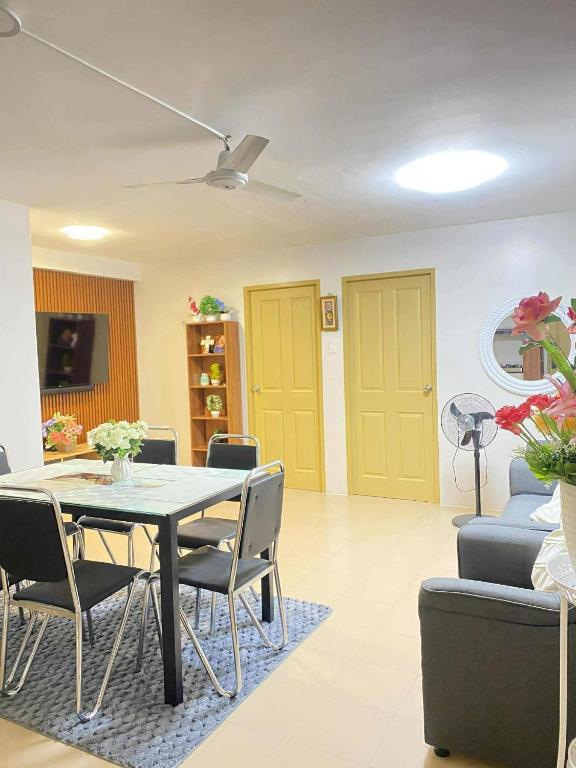 a living room with a table and chairs and a couch at ONE SPATIAL 2Bedrooms Apartment Flat LLD Iloilo City Philippines in Iloilo City