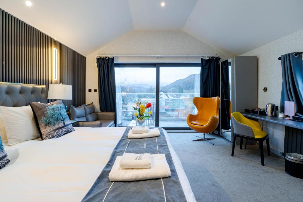 a hotel room with a large bed with a view at Waterhead Bath Suites - Parking and Light Breakfast in Ambleside