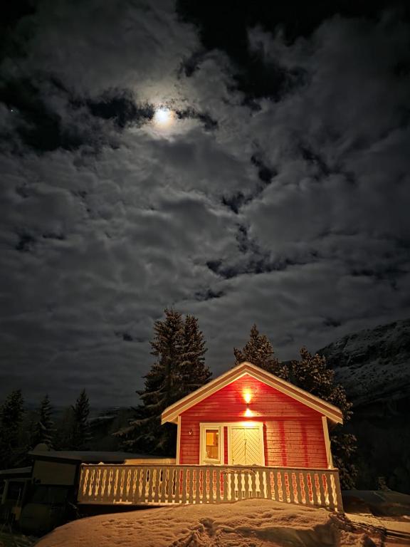 a small house with a moon in the sky at Sobakken Camping in Bardu