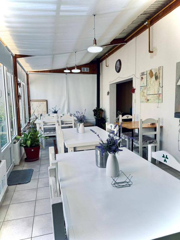 a restaurant with tables and chairs and a clock on the wall at Isla Bella in Ushuaia