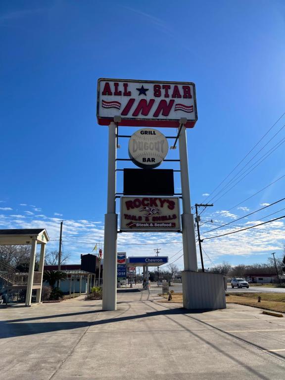 a sign for a all star gym on a street at All Star Inn in Bunkie