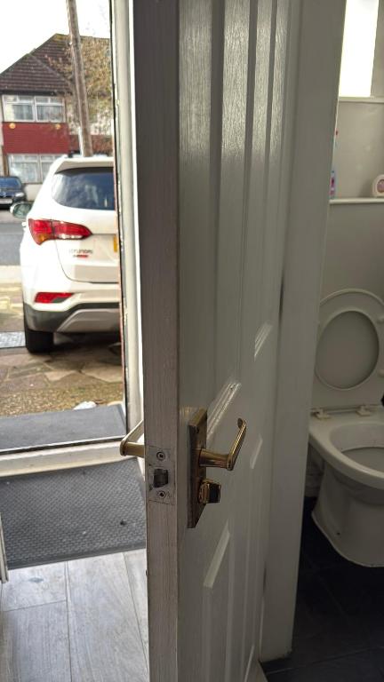 an open door to a bathroom with a toilet at Bel City in Thornton Heath