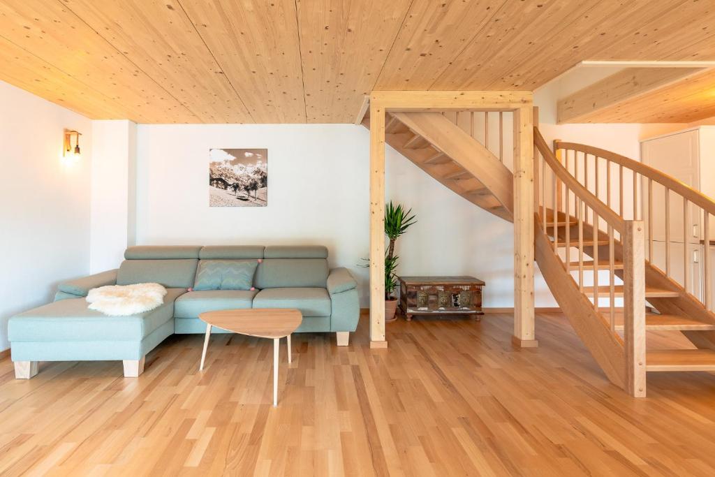 a living room with a couch and a staircase at Sigelalp in Blaichach