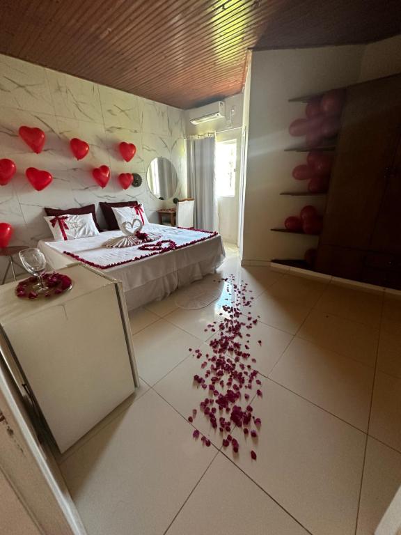 a bedroom with a bed with red petals on the floor at Mirante Pai Inácio in Lençóis