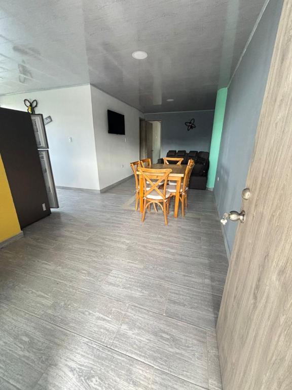 a dining room with a table and chairs in a room at Apartamentos campestres la Divisa in Santa Rosa de Cabal