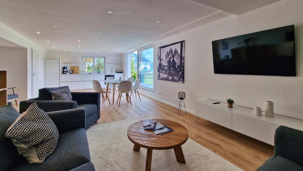 a living room with two couches and a table at Chalet 44 in Ofterschwang