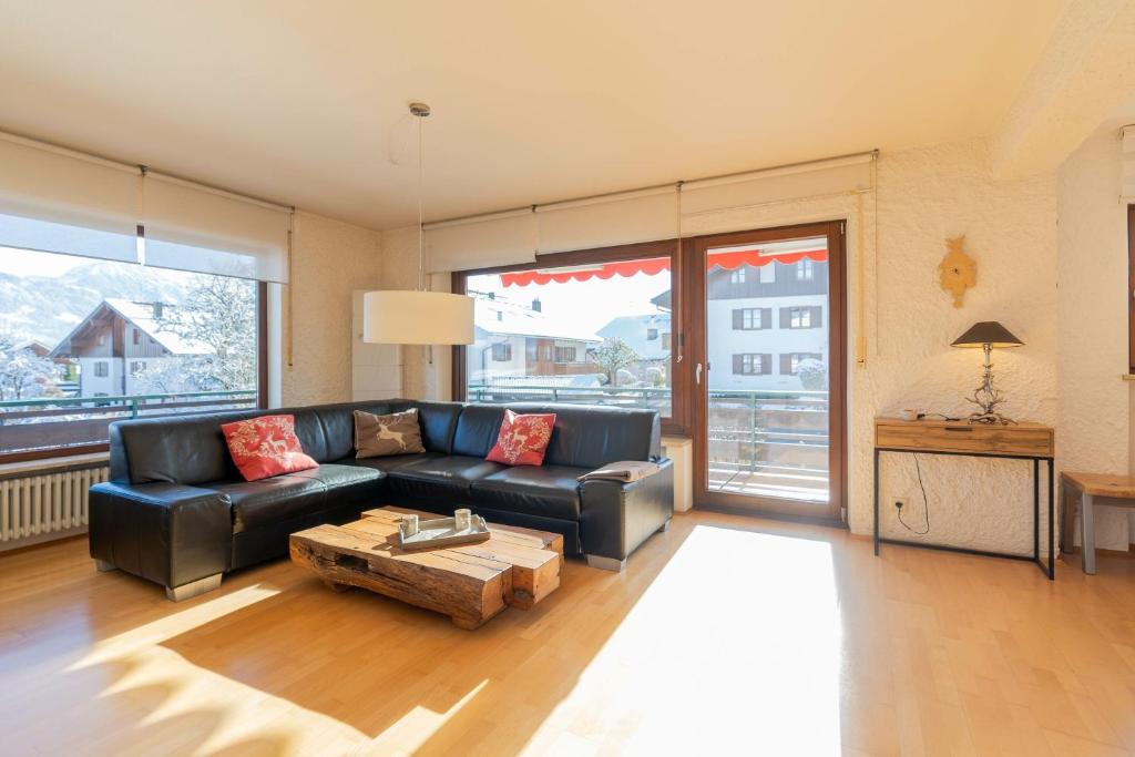 a living room with a couch and a coffee table at Entschenkopf in Bolsterlang