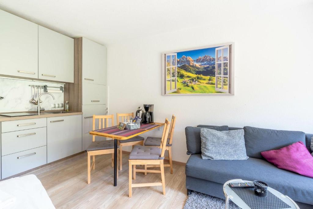 a living room with a blue couch and a table at Ferienwohnung Manns in Bad Hindelang