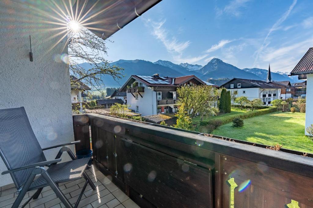 a balcony with a chair and a view of mountains at Ifen in Fischen