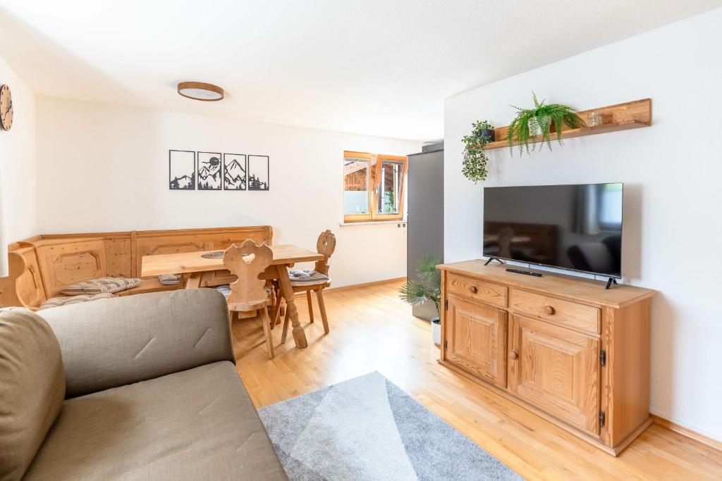 a living room with a couch and a table at Stolz 1 in Blaichach