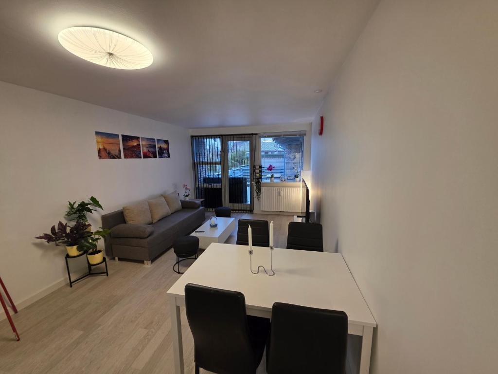 a living room with a table and a couch at 2 room apartment in Horsens in Horsens