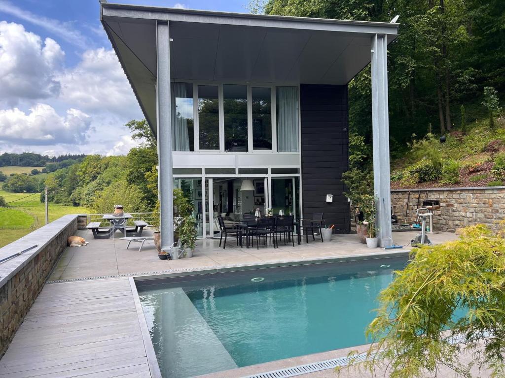 a house with a swimming pool in front of it at The Sweet Escape Premium villa with pool in Theux