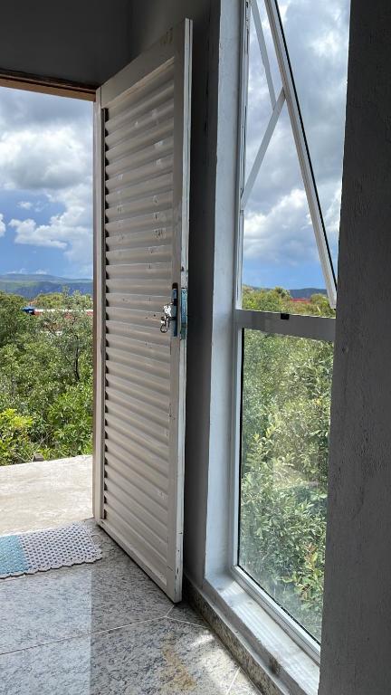 an open door in a room with a window at Flat Recanto Brados in Sao Jorge