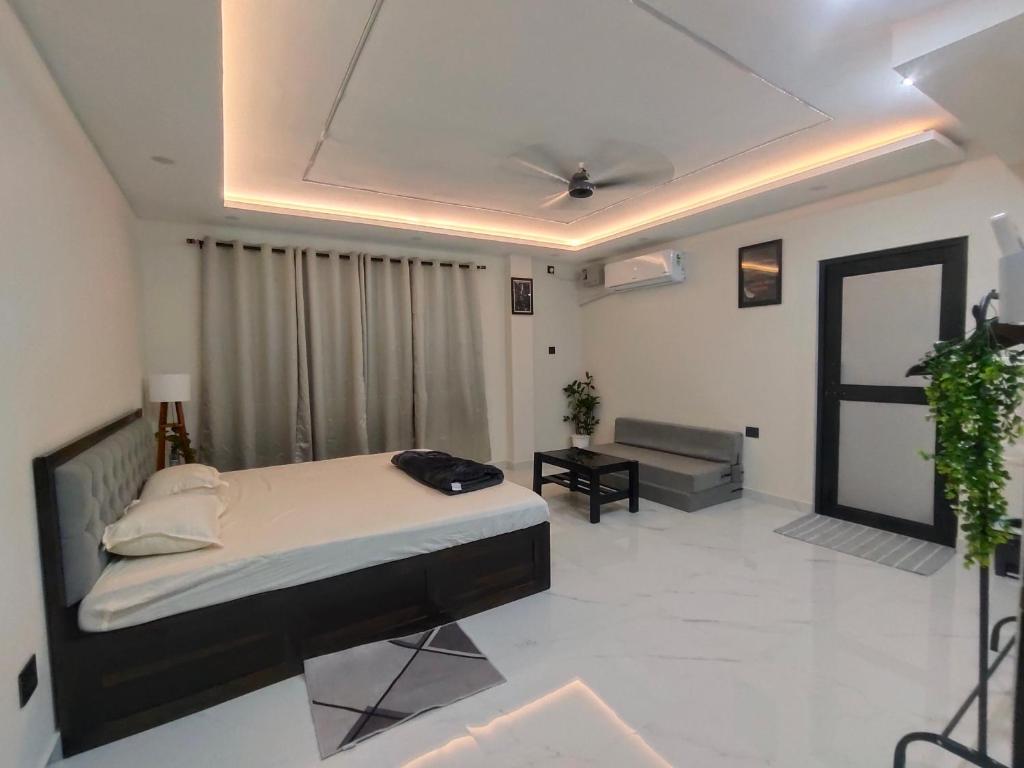 a bedroom with a bed and a couch in it at IMSONG'S humble abode in Dimapur