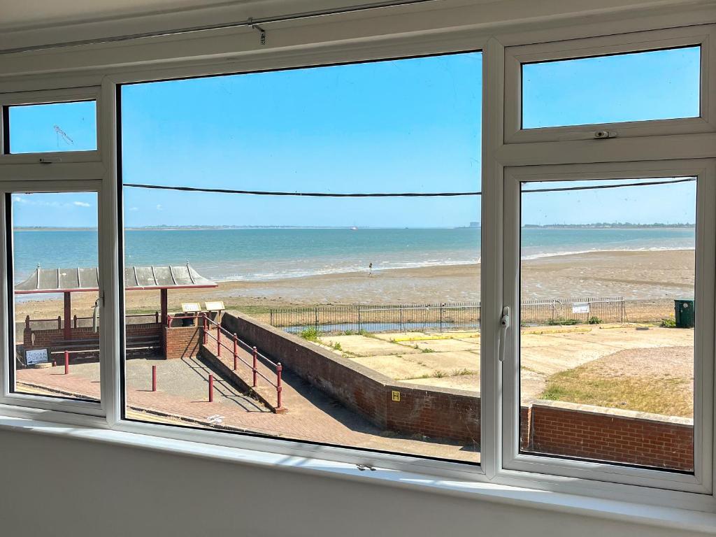a view of the beach from a window at Thirslet in Maldon