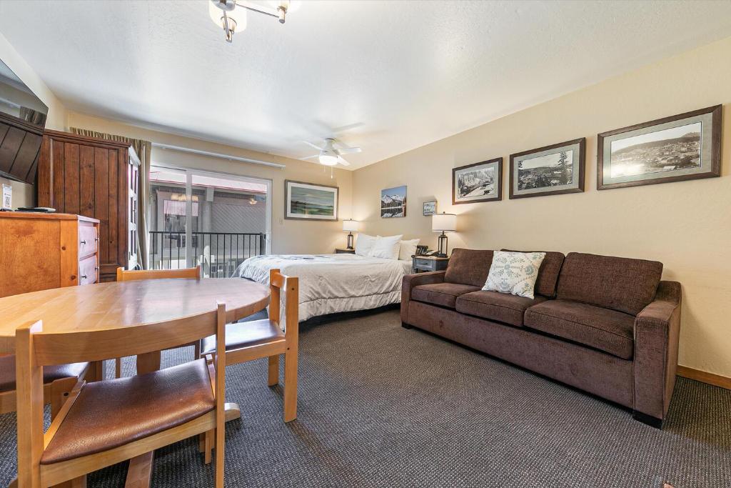a room with a bed and a couch and a table at Cozy Studio wKitchen #217 at Donner Lake Village in Truckee