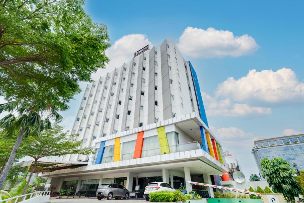a building with colorful stripes on the side of it at JP Hotel Pluit Jakarta by LIFE in Jakarta